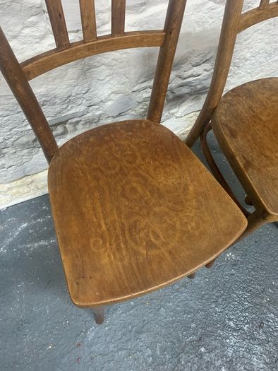 A pair of tall Thonet bentwood chairs.