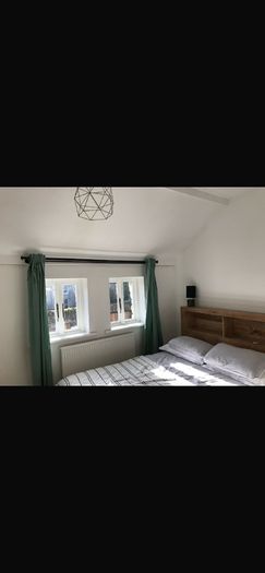 Solid wood king size bed with in built shelves at back