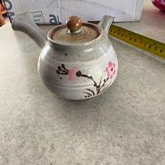 Japanese Side-Handle Teapot Kyusu 300cc  speckled ceramic side-handle teapot (kyusu) features a hand-painted pink cherry blossom (sakura) or plum floral branch motif against a light gray or cream stoneware body