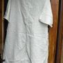 Off white linen button-down  longline tunic featuring a relaxed, oversized silhouette. Image 2
