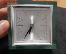 This is an Acctim Hamilton mantel clock made of glass and metal.