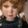 Vintage porcelain doll in green velvet dress Image 2