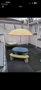 Picnic bench with parasol and sand/water table
