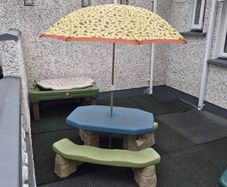 Picnic bench with parasol and sand/water table