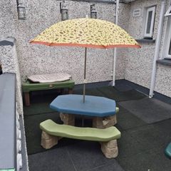Picnic bench with parasol and sand/water table