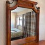 Crafted from stained hardwood with raised drawer panels, rounded pedestal edges, and an arched top mirror crown bordered by heavy metal or wood accent brackets. Nautical Rope Detailing: The upper accent panels on the mirror frame, the top left drawer, and Image 6