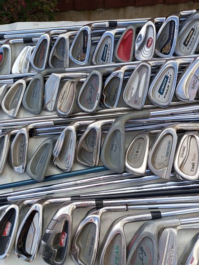 A selection of golf clubs and bags. All right handed clubs.