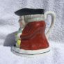 An antique TOBY JUG (Staffordshire potteries) - a seated toby holding his ale jug and cup (late 19th century). Excellent condition. About 14cm height. Image 4