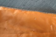 Solid orange satin look piece of fabric with beads