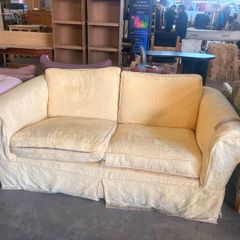 Butter yellow two seater sofa