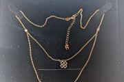 silver pendant with two shamrocks and two lil stones