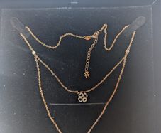 silver pendant with two shamrocks and two lil stones