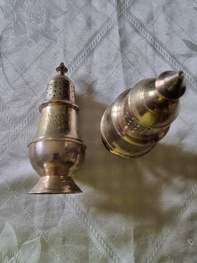 A pair of silver-plated salt shakers