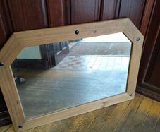 Large pine mirror decorated with black studs