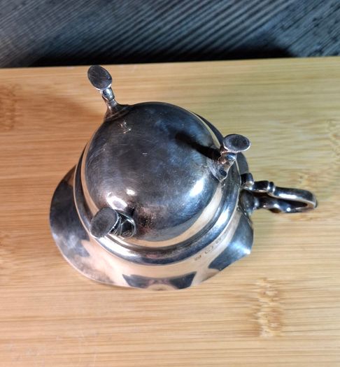 Antique silver cream jug with scalloped rim