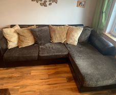 brown leather L-sofa and single armchair