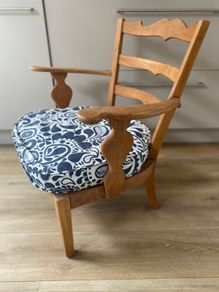 Vintage wooden armchair with cushion