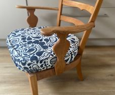 Vintage wooden armchair with cushion