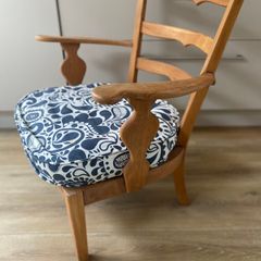 Vintage wooden armchair with cushion