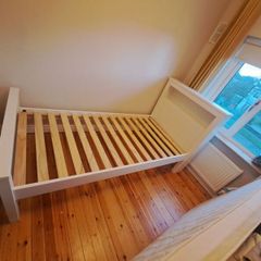 White single bed with bookcase headboard