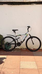Rockway mountain bike silver and black frame with green accents and a full suspension system.
