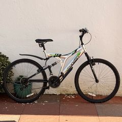 Rockway mountain bike silver and black frame with green accents and a full suspension system.