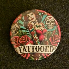 Tattooed , pin back button badge.
