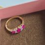 Beautiful yellow gold ring featuring three stunning rubies surrounded by sparkling cubic zirconia stones. Size M, in beautiful condition. Image 8