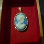 Vintage Cameo Goldtone Pendant on a Blue Background Image 4