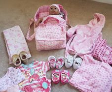 Doll, Carrycot, quilt and clothes
