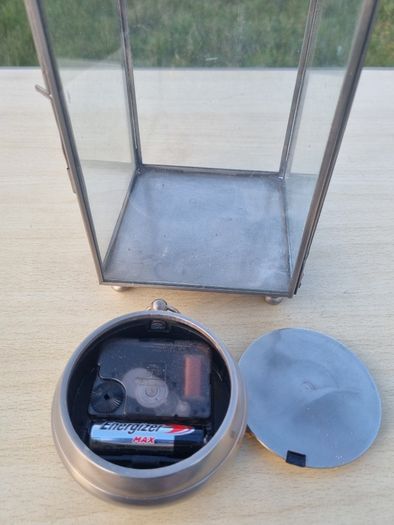 Table clock in a glass lantern.
