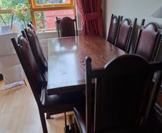Dark Oak Dining room table and 8 leather chairs.