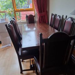 Dark Oak Dining room table and 8 leather chairs.
