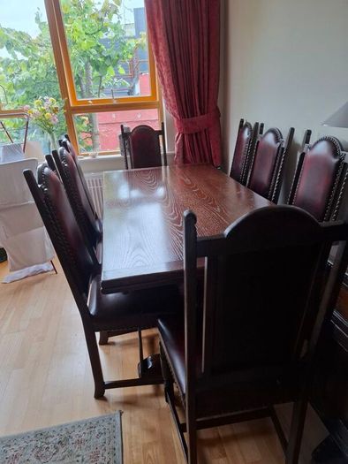 Dark Oak Dining room table and 8 leather chairs.