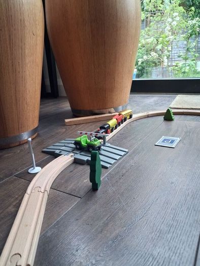 wooden train track set with wooden trains and accessories.