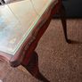 Vintage Queen Anne-style wooden coffee table featuring cabriole legs, a glass top protecting an inset leather surface with gold tooling Image 5
