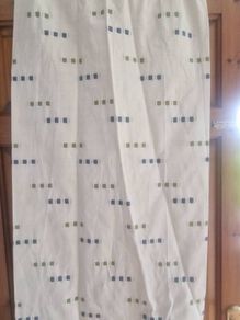 cream heavy curtains with ble & green pattern