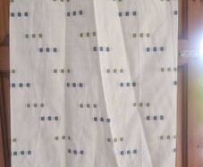 cream heavy curtains with ble & green pattern
