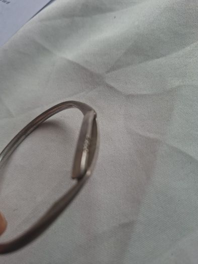 Sculptural sterling silver bangle with three tiny diamond accents.