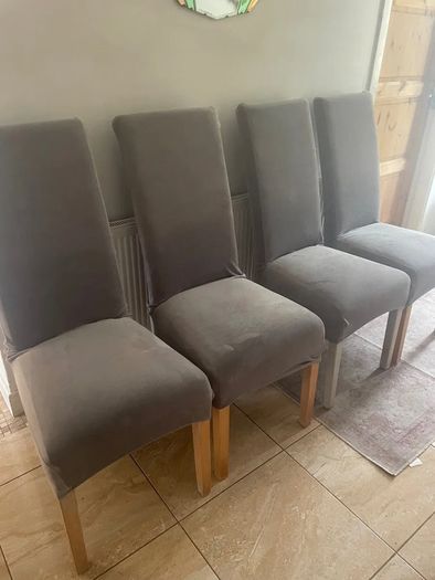 4 dark brown dining room chairs & 4 stretch covers