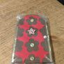 handcrafted wooden  Fairy door with red cardstock, brown flower cutouts, and decorative buttons.  various buttons acting as handles or embellishments. Image 3
