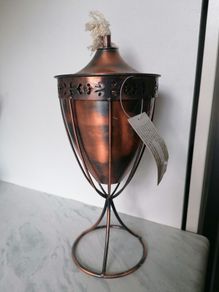 Copper-finished metal outdoor garden oil torch or tabletop tiki-style torch with a wick and stand
