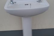 Bathroom sink with pedestal, taps and trap