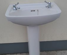 Bathroom sink with pedestal, taps and trap
