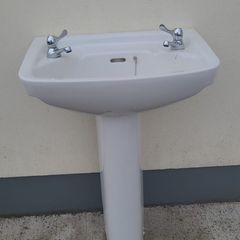 Bathroom sink with pedestal, taps and trap