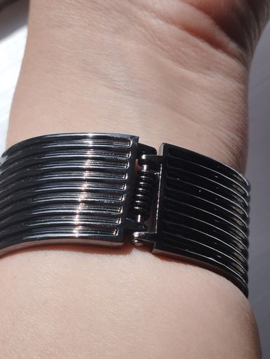 A striking wide bracelet encrusted with sparkling rhinestones.