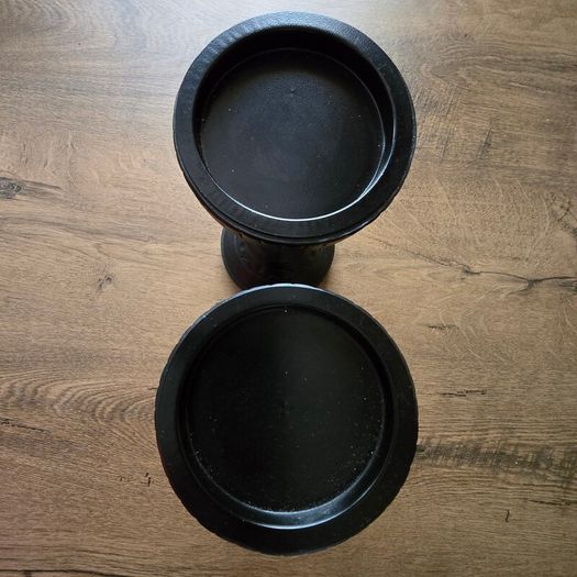 A pair of black candle holders