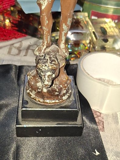 A Pair of Antique French Spelter Statues titled La Force (The Strength) and Le Pouvoir (The Power). The feature a male and female figure standing a top lions, raising up flaming torches