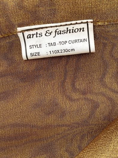 A Pair of Tab Top Voile Curtains. ( Gold) 110 x 230 cm New.