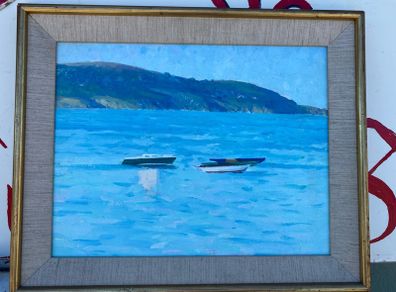 Seascape depicting small boats moored in a calm harbour with hills in the background unsigned